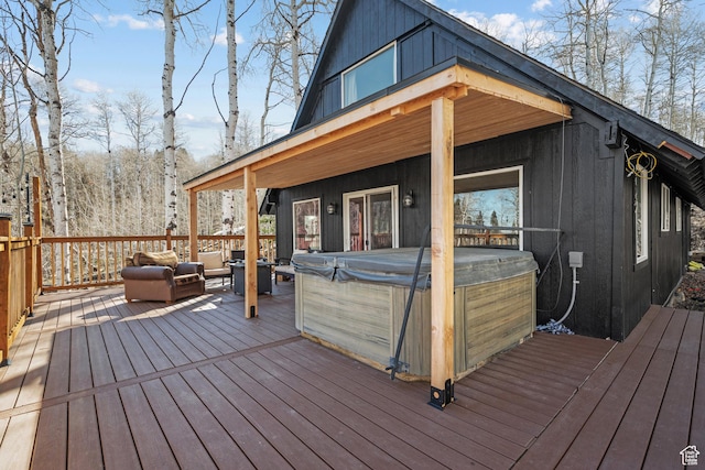 wooden deck featuring a hot tub and an outdoor hangout area
