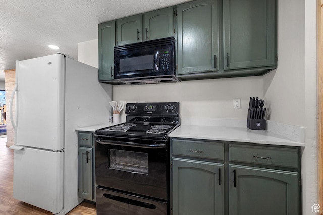 kitchen featuring black appliances, green cabinets, light countertops, a textured ceiling, and light wood-style floors