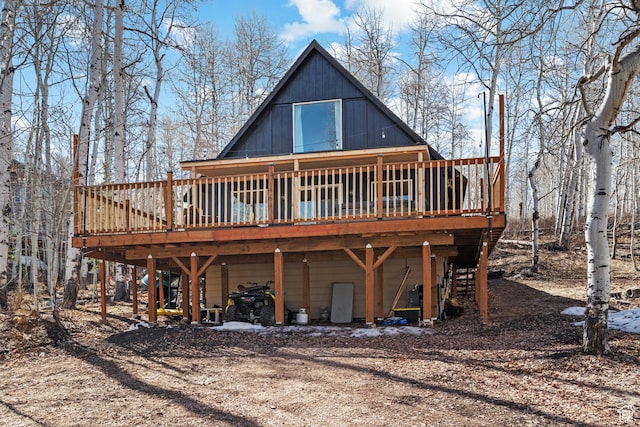 rear view of house with a wooden deck and a carport