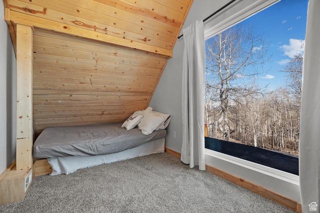 bedroom with carpet, lofted ceiling, and wooden ceiling