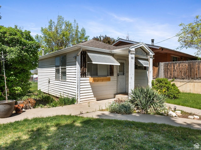 view of front of home featuring fence and a shingled roof