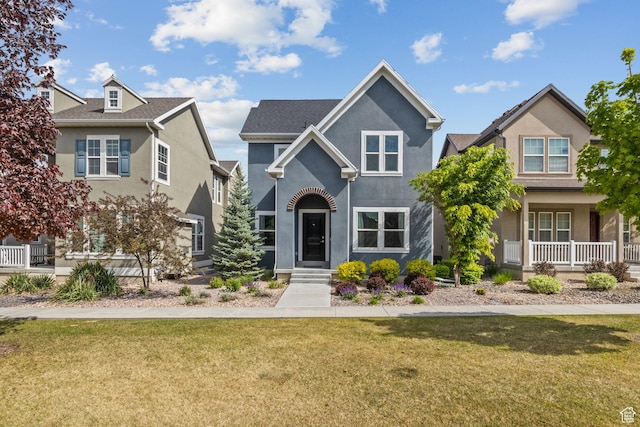 traditional-style house featuring stucco siding and a front yard