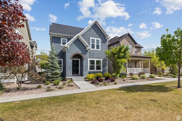 traditional-style house featuring stucco siding and a front lawn