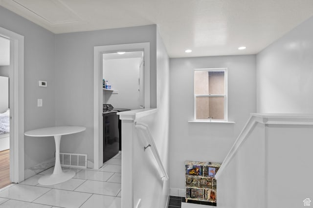 hallway with baseboards, recessed lighting, and an upstairs landing