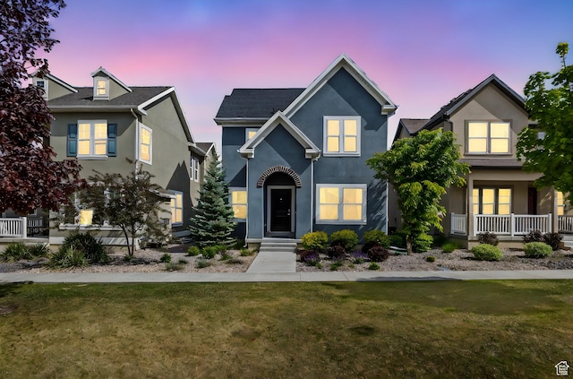 traditional-style house with stucco siding and a front yard