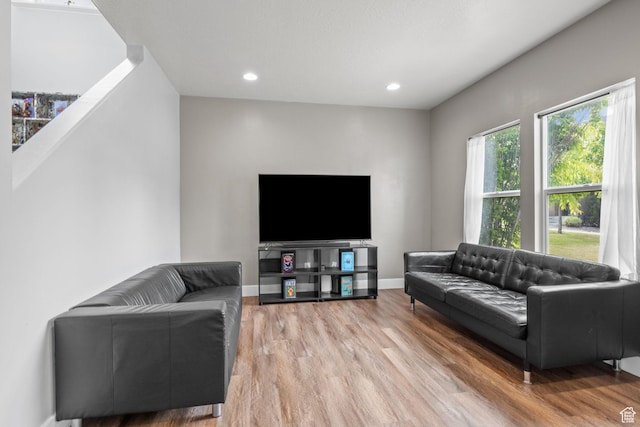living area with wood finished floors, baseboards, and recessed lighting