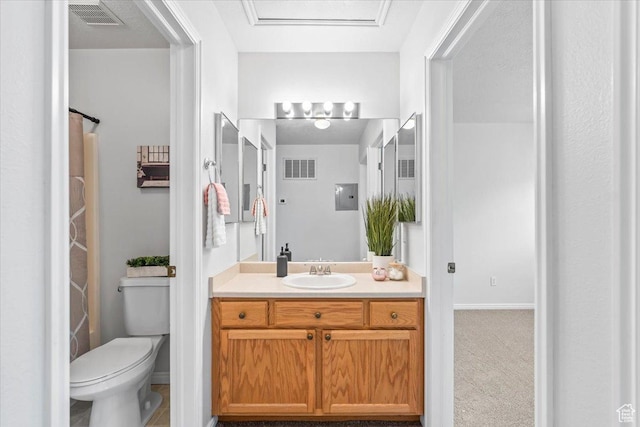 bathroom featuring vanity, toilet, and baseboards
