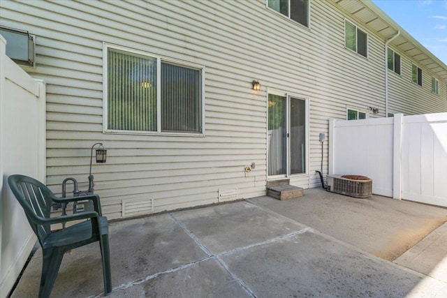 back of house featuring a patio area, fence, and central AC unit