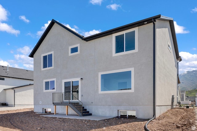 back of house with stucco siding