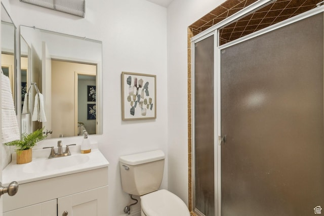 full bathroom with a shower stall, toilet, and vanity