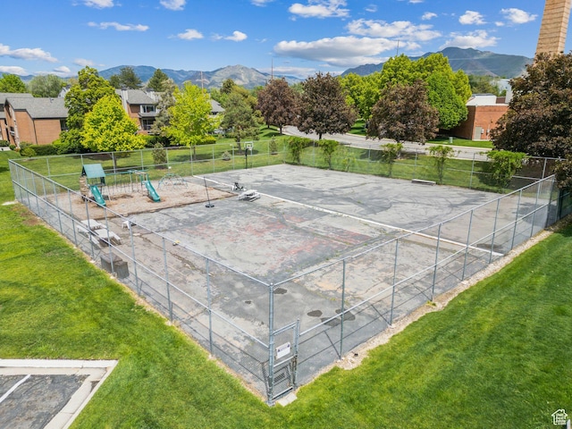view of tennis court featuring a mountain view