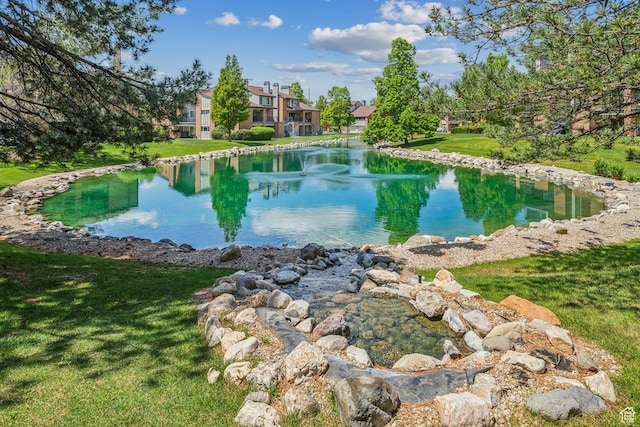 view of swimming pool with a water view