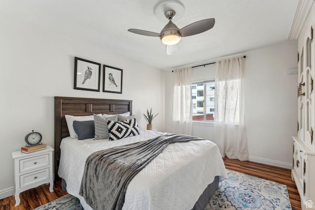 bedroom with wood finished floors, baseboards, and ceiling fan