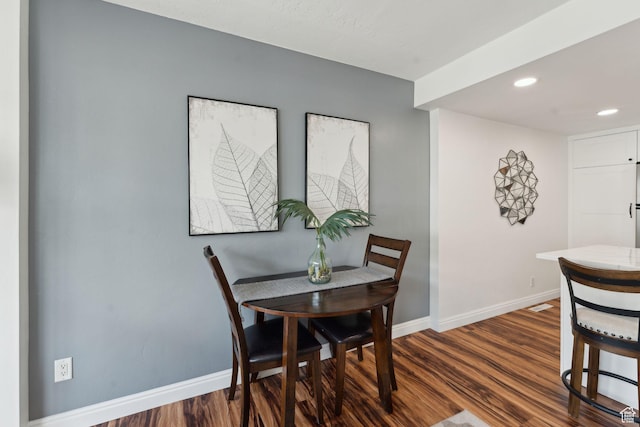 dining area featuring baseboards, dark wood-type flooring, and recessed lighting