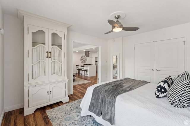 bedroom with dark wood finished floors, baseboards, ceiling fan, a closet, and french doors