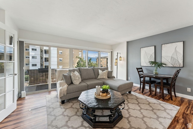 living area featuring wood finished floors and baseboards
