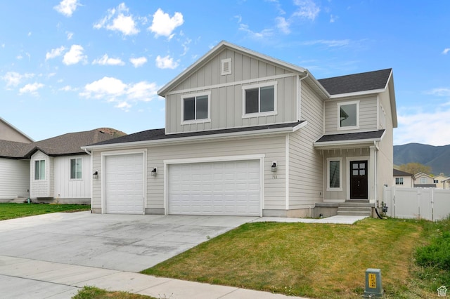 traditional home featuring board and batten siding, concrete driveway, and a mountain view