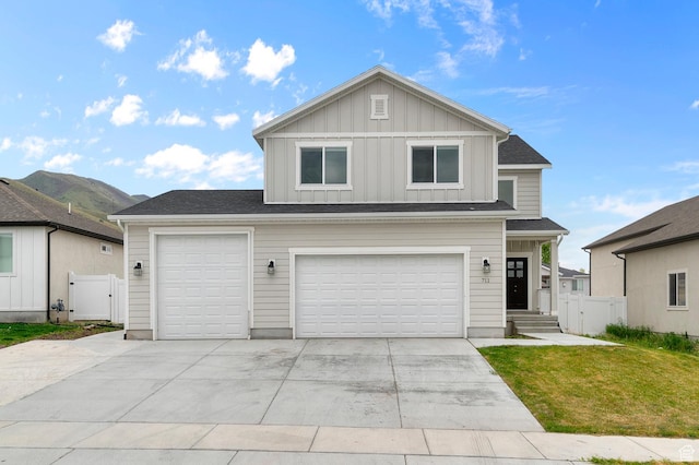 view of front facade featuring board and batten siding, concrete driveway, a gate, and an attached garage