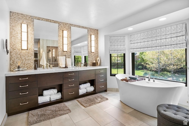 bathroom featuring vanity, a soaking tub, and recessed lighting