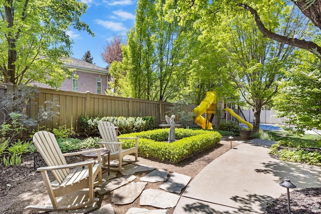 view of patio / terrace with a playground and a fenced backyard