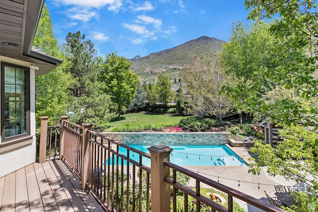 outdoor pool featuring a deck with mountain view