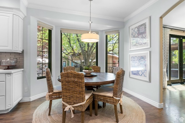 dining room with baseboards, dark wood-type flooring, and ornamental molding