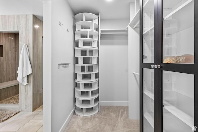 walk in closet featuring carpet