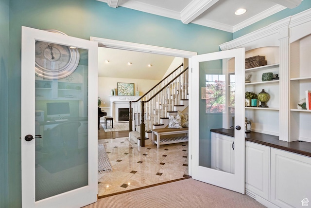 entryway featuring french doors, crown molding, stairs, beam ceiling, and a fireplace