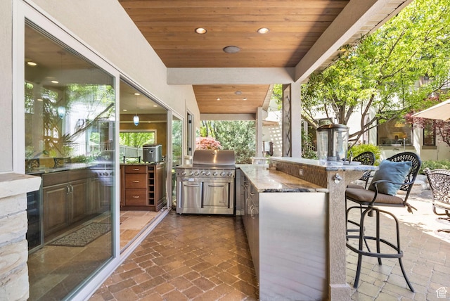 view of patio / terrace with an outdoor kitchen and a grill