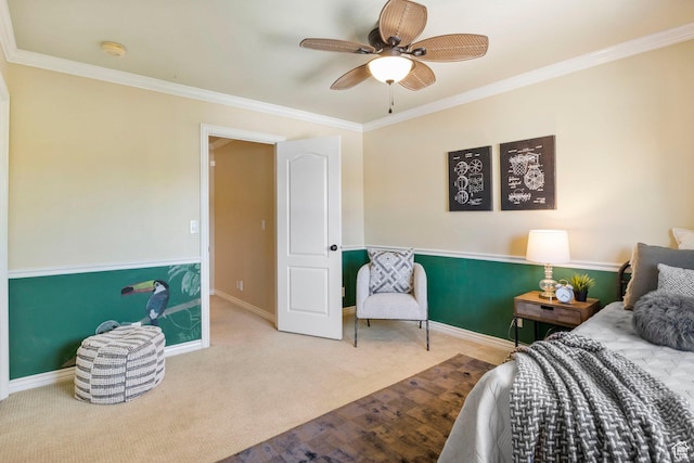 carpeted bedroom featuring ornamental molding, baseboards, and a ceiling fan