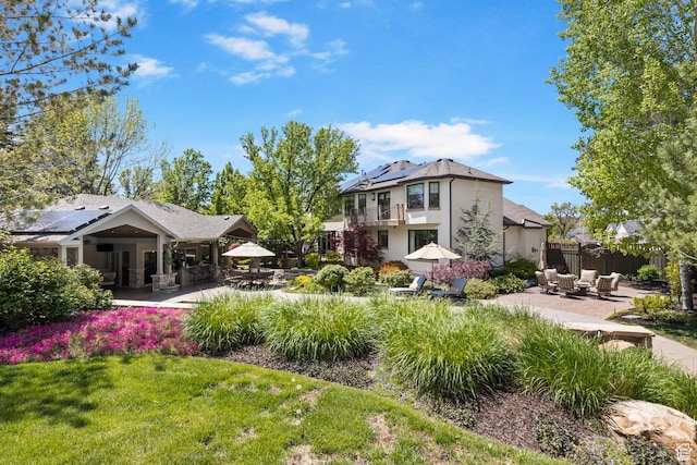 view of yard with a patio, a balcony, and an outdoor hangout area
