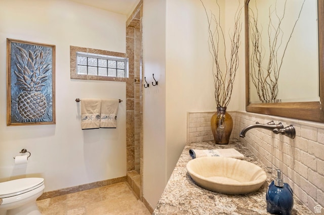 full bathroom with toilet, walk in shower, vanity, and baseboards