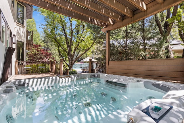view of swimming pool with a hot tub
