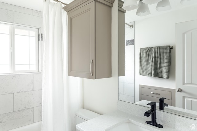 full bathroom featuring toilet, vanity, and shower / bath combo with shower curtain