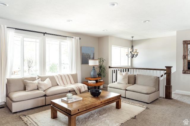 living area featuring a chandelier, plenty of natural light, light colored carpet, baseboards, and recessed lighting