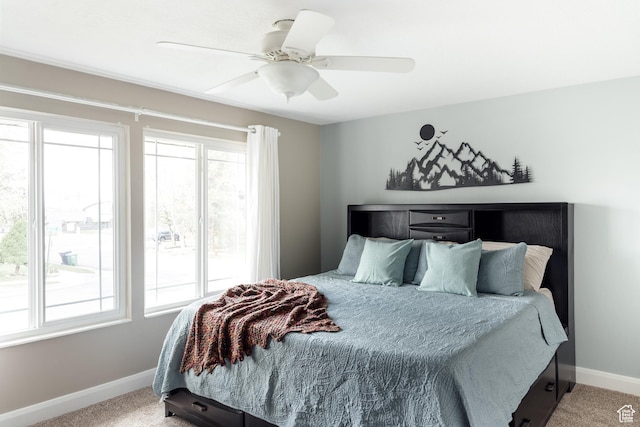 bedroom with baseboards, multiple windows, and light colored carpet