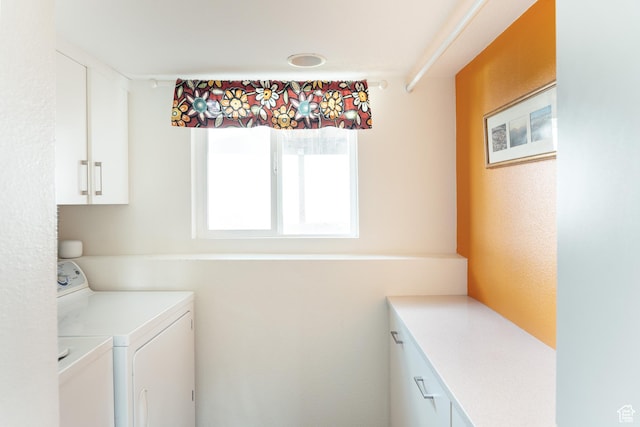 washroom with cabinet space and independent washer and dryer