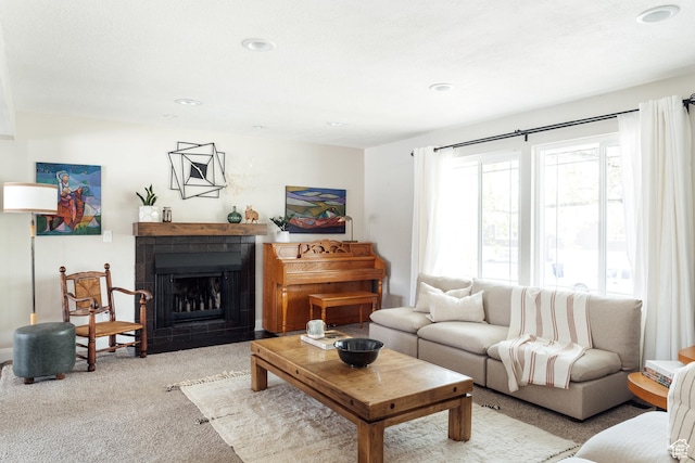 living room featuring carpet flooring, a fireplace with flush hearth, and recessed lighting