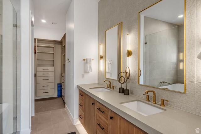 833 W Savoy Ln, St George, UT 84790 - bathroom with tile patterned floors, a spacious closet, a tile shower, double vanity, and backsplash