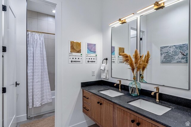 833 W Savoy Ln, St George, UT 84790 - bathroom featuring shower / tub combo, double vanity, and baseboards
