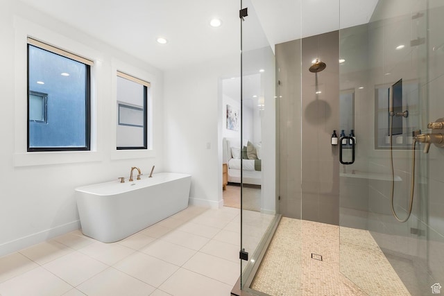 ensuite bathroom featuring baseboards, a shower stall, and recessed lighting