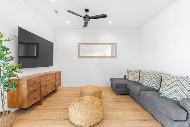 living area with light wood-style floors, ceiling fan, recessed lighting, and baseboards