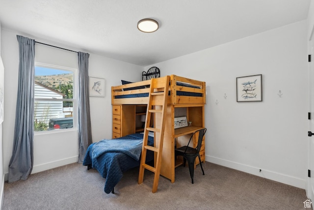 carpeted bedroom featuring baseboards