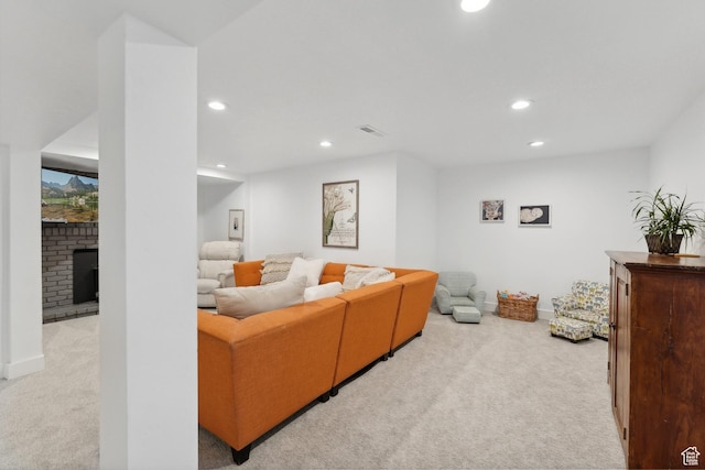 living area with carpet flooring, recessed lighting, a brick fireplace, and baseboards