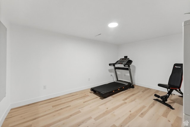 exercise area featuring wood finished floors and baseboards