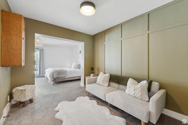 carpeted bedroom featuring baseboards