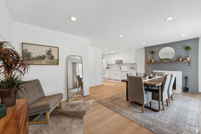 dining room with light wood-style floors and recessed lighting