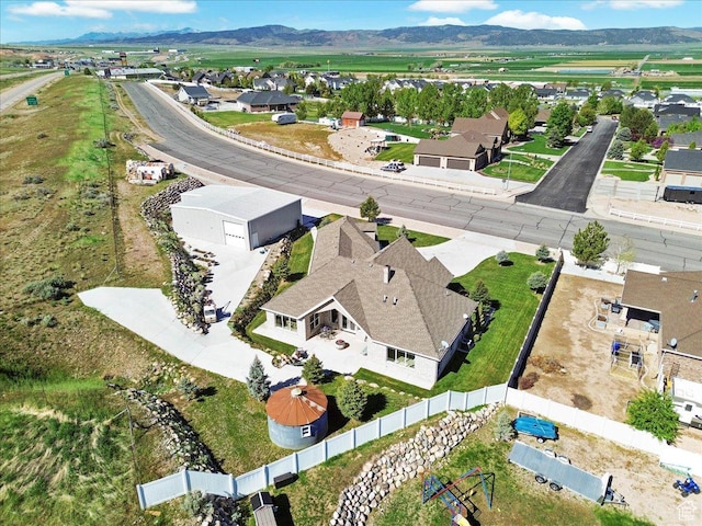 aerial view of property and surrounding area with a mountain backdrop and nearby suburban area