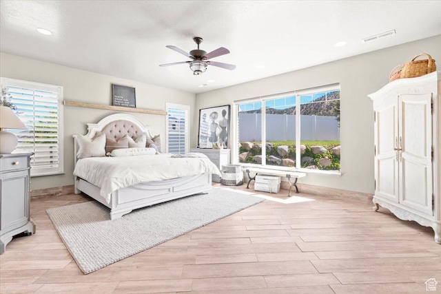 bedroom featuring light wood-type flooring, multiple windows, recessed lighting, and ceiling fan