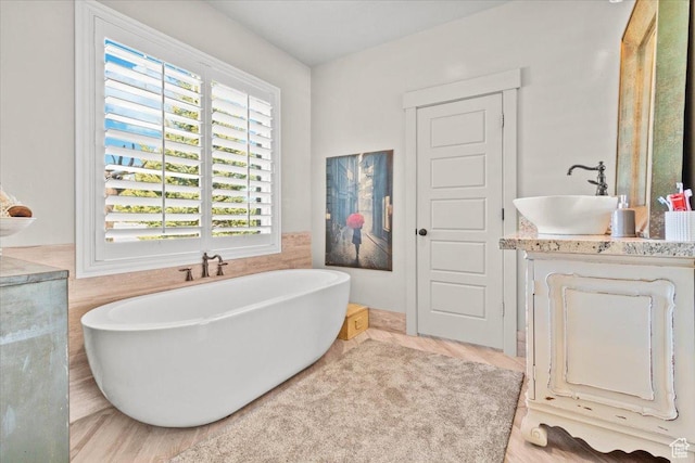 bathroom with a freestanding bath and vanity